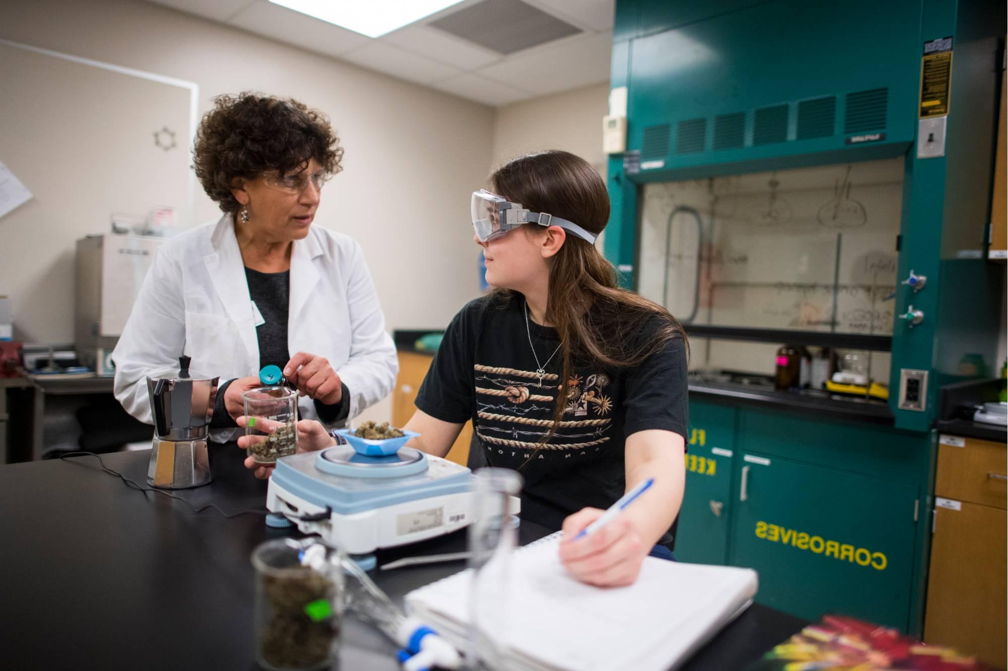 A GVSU student studies with a professor in one of Grand Valley's science labs.